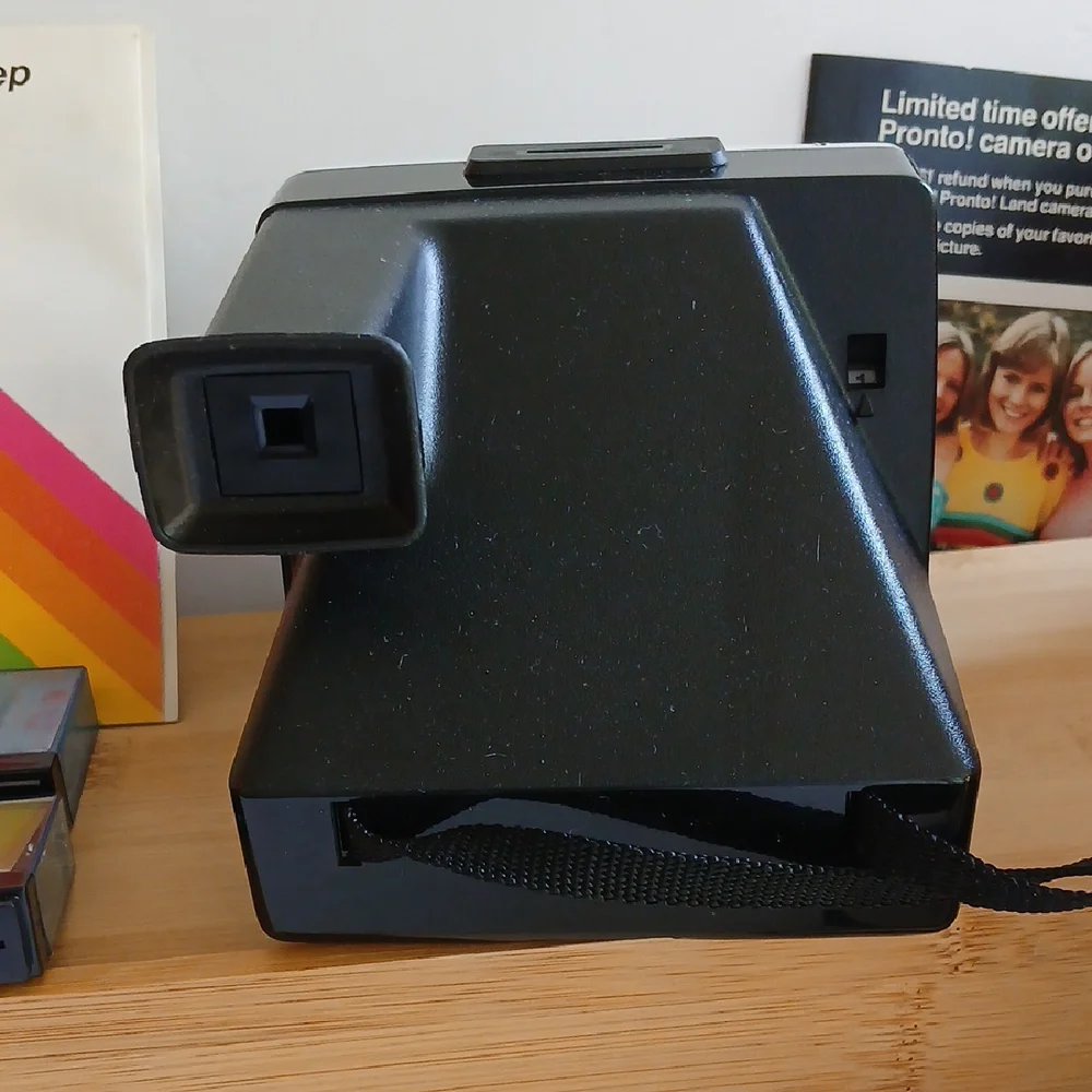 Vintage Polaroid Land One Step Instant Film Camera with Iconic Rainbow Design